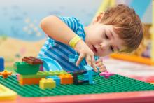 Child playing with Lego