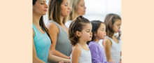 Parents and children practicing yoga