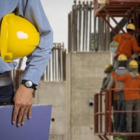 Inspector with hard hat at building site